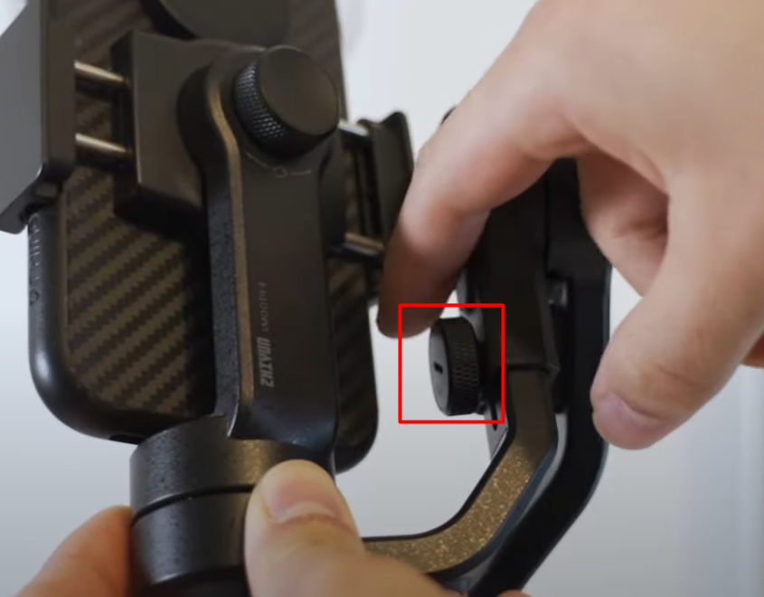 There’s a knob and sliding arm on the side. Now, you need to loosen the knob